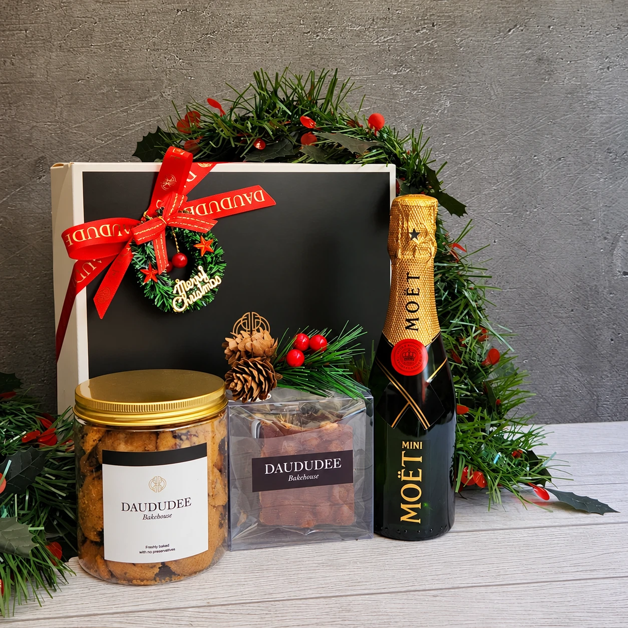 Christmas gift box with mini champagne, cookies and chocolate