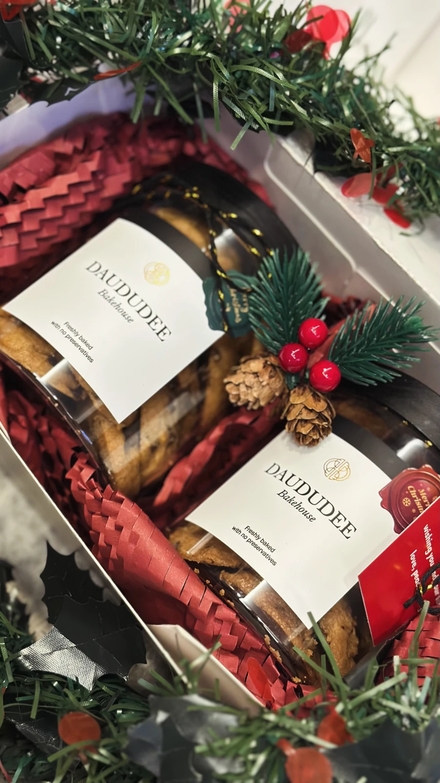 Two-jar Christmas cookie gift box with red paper and pinecone decoration