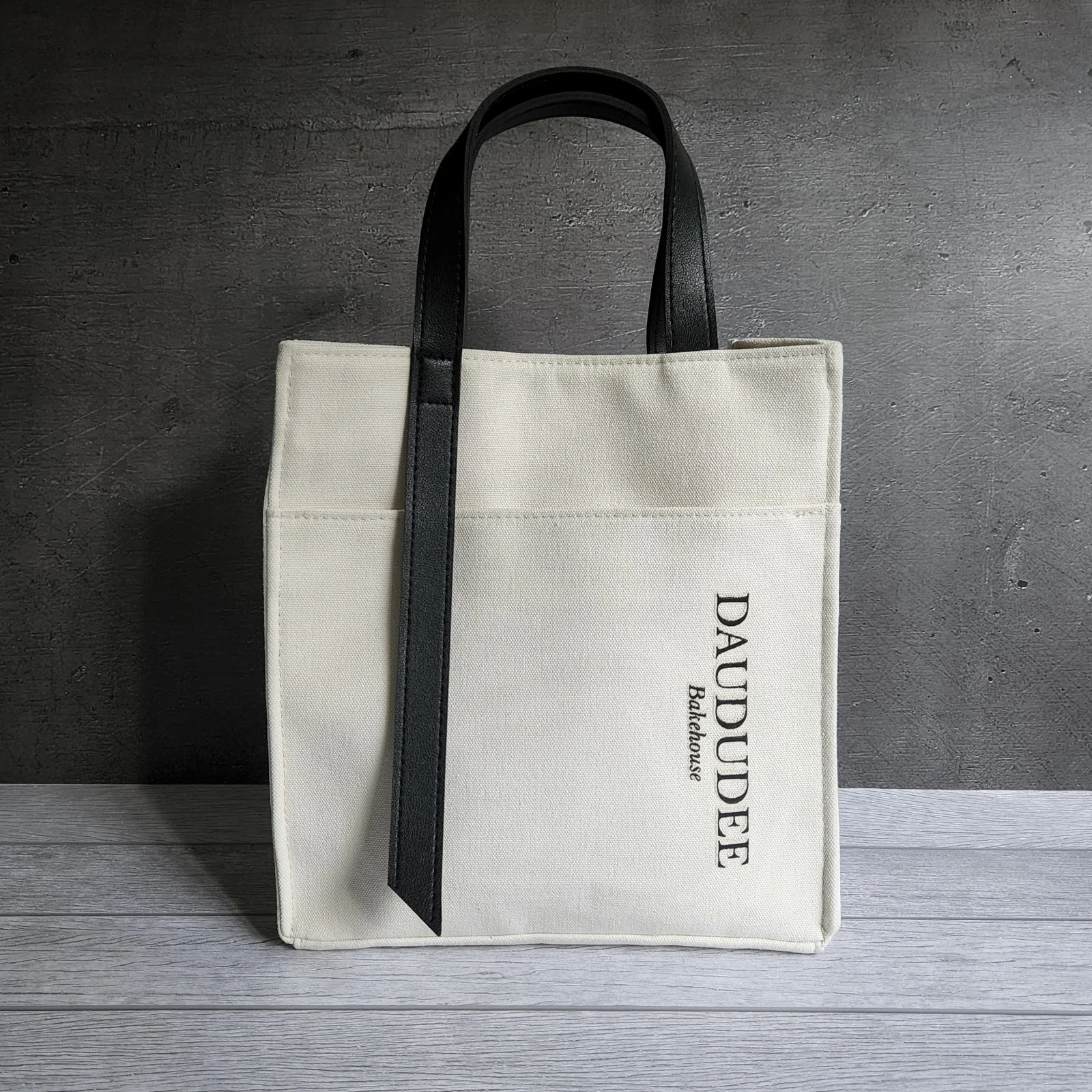 Canvas tote with contrasting black handles