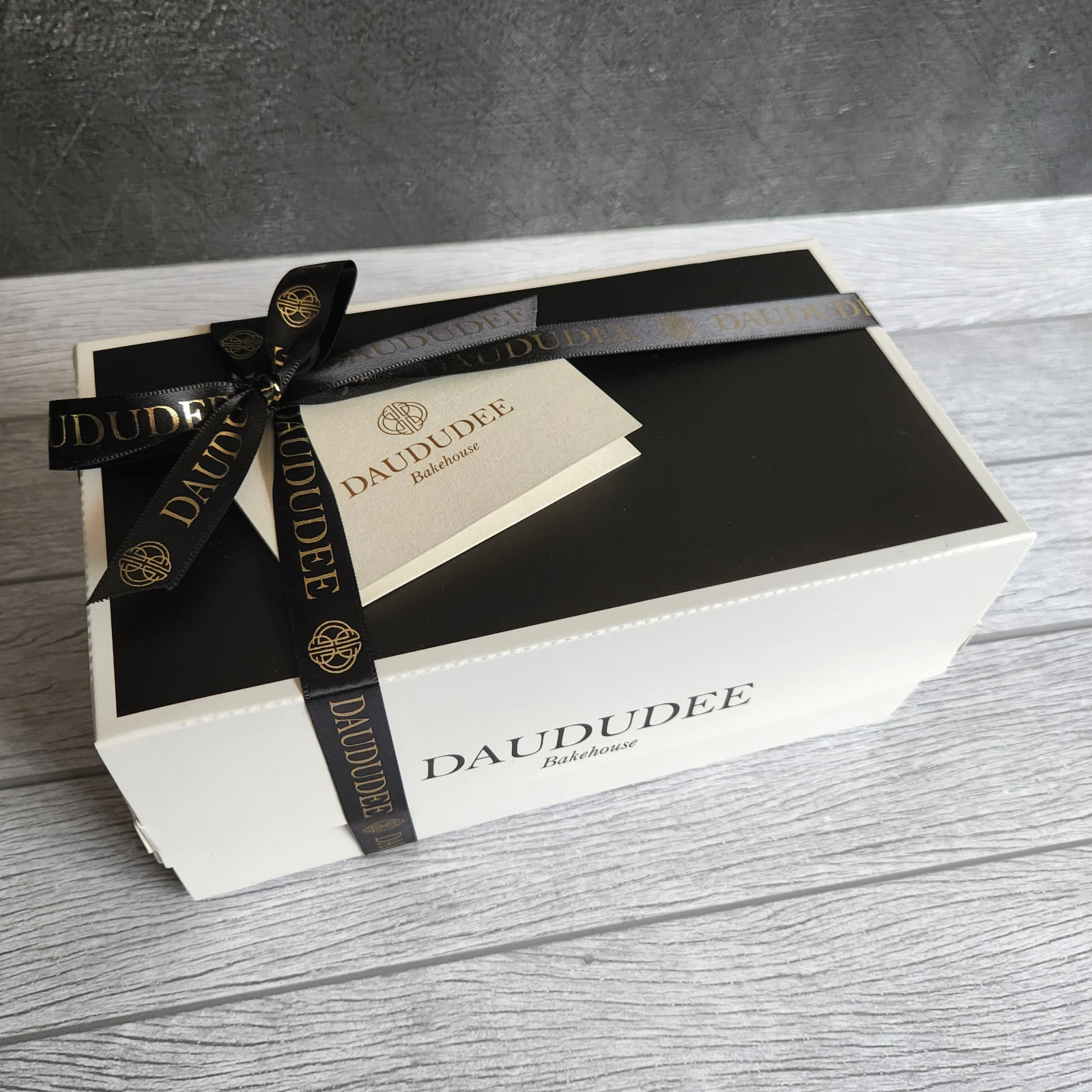 Classic gift box finished with black and gold ribbon