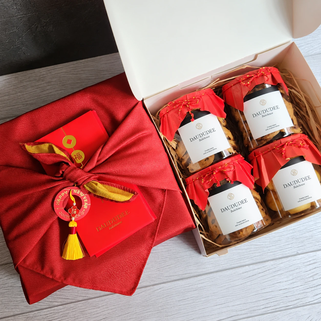 Four-jar gift box with red fabric wrapping and tassel