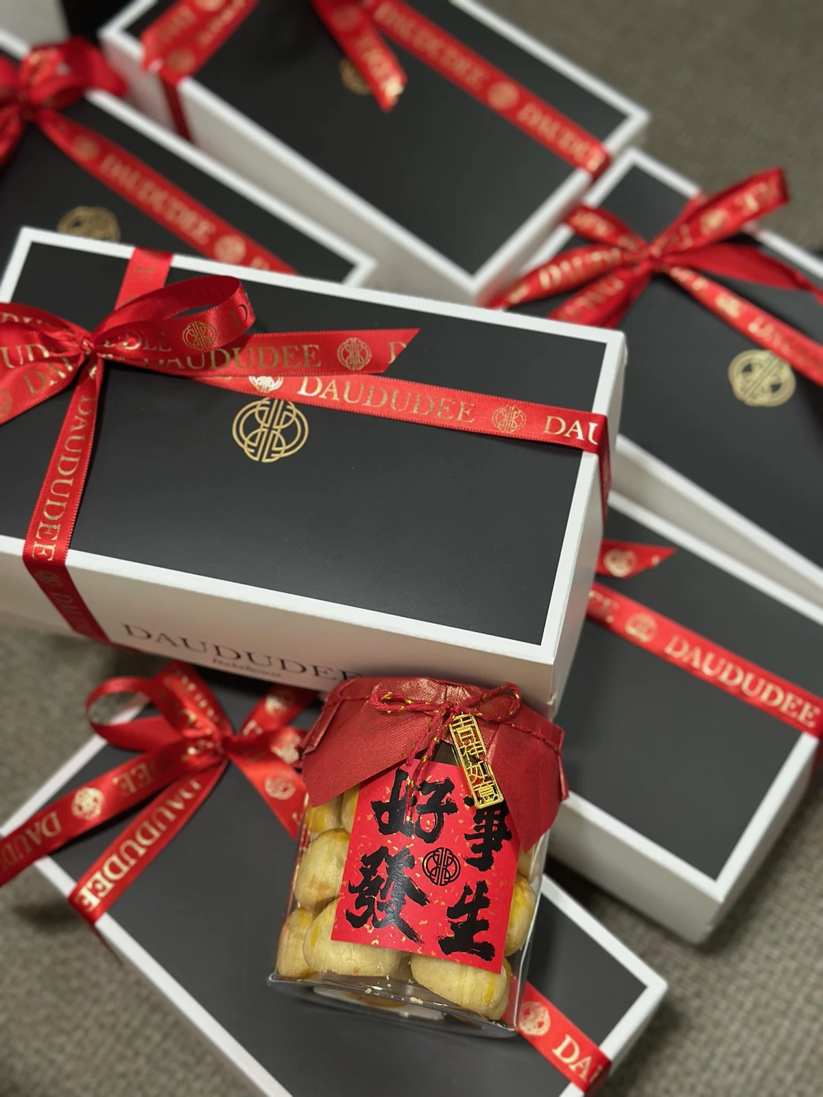 Lunar New Year cookie gift boxes finished with red and gold ribbon